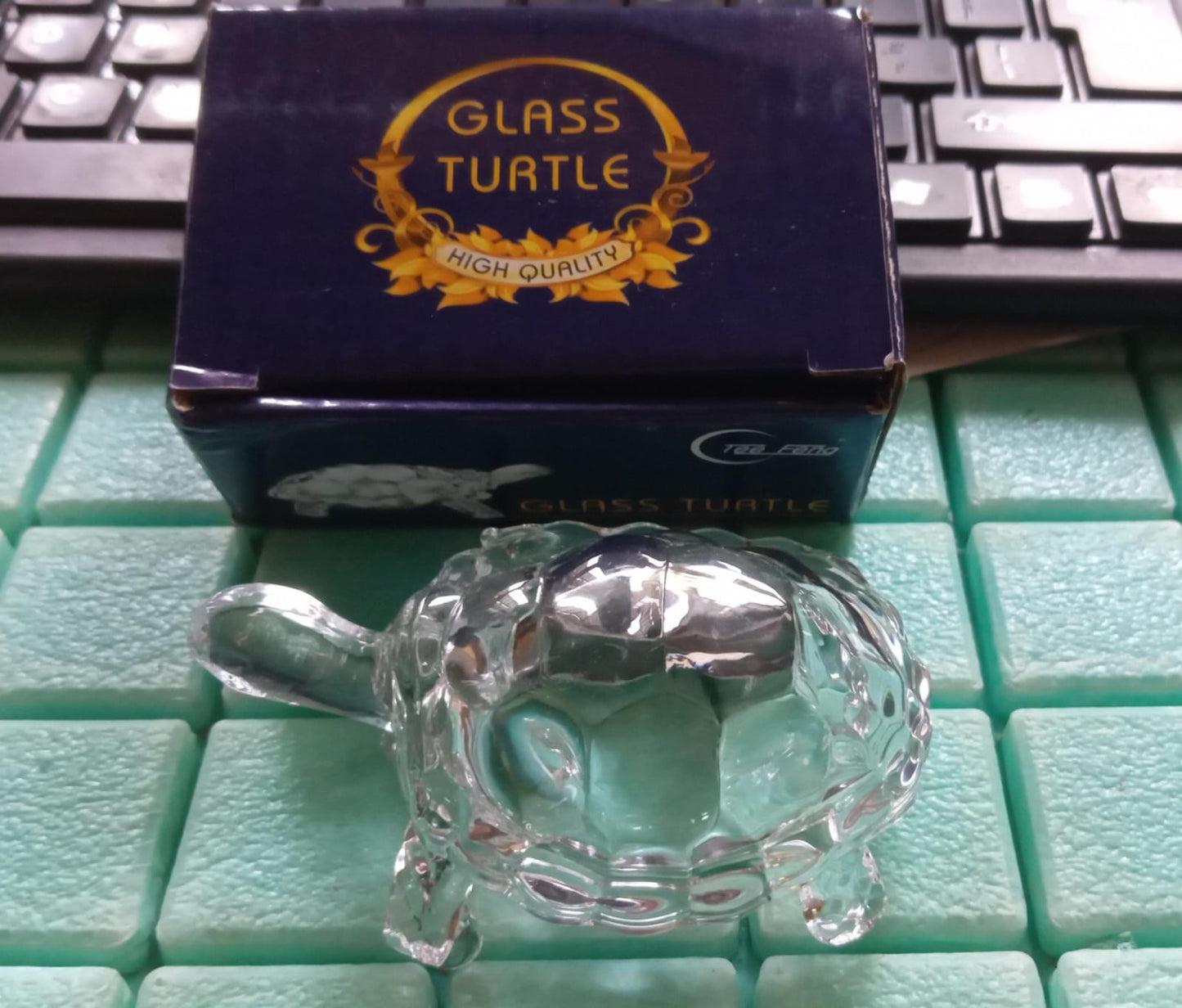Decorative Feng Shui crystal turtle in a transparent finish, promoting peace.