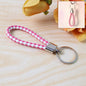 Braided leather keychain featuring durable metal ring and two-tone braid design