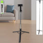 Adjustable selfie stick with tripod stand and Bluetooth remote in use