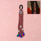 Traditional multicolor braided hair accessory with shells and tassels