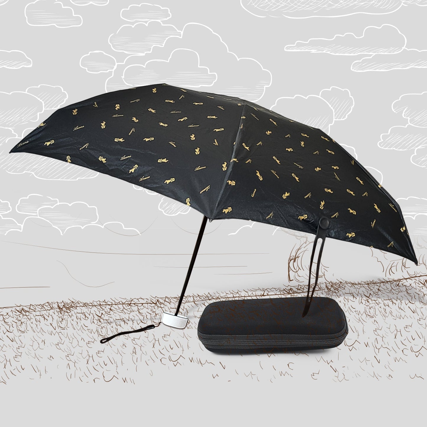 A black DrizzlePro umbrella with small gold musical note patterns is open next to its black zippered case on a sketched