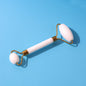 Dual-ended face massage roller with cooling stone heads on a clean background.