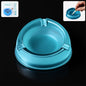 Transparent plastic ashtray with three cigarette rest slots and wide bowl