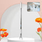 Telescopic clothes hook extended, reaching high garments in a closet.