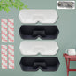 White wall with four adhesive sunglasses holders, displaying various eyewear.