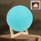 A serene blue Moon Night Lamp illuminating a dark room, creating a calming ambiance.