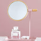 Round tabletop makeup mirror with wooden finish frame on vanity table