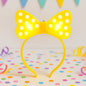 Front view of LED glowing bow hairband with polka dots for kids