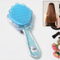 A vibrant cartoon-themed kids' detangling hair brush with a playful design, ideal for gentle combing.