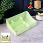 Green multi-section desk organizer storage tray on desk organizing office supplies