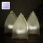 Set of three flameless LED lantern lights with frosted ribbed design emitting warm glow