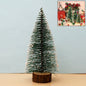 Mini artificial Christmas tree with realistic snow effect on branches and wooden base