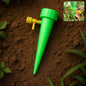Plant Watering Spike gently watering potted plants in garden