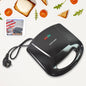 Dabster 2-slice sandwich maker with non-stick plates on a kitchen counter.