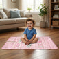 A happy baby playing on a reversible Baby Play Mat with an animal theme.