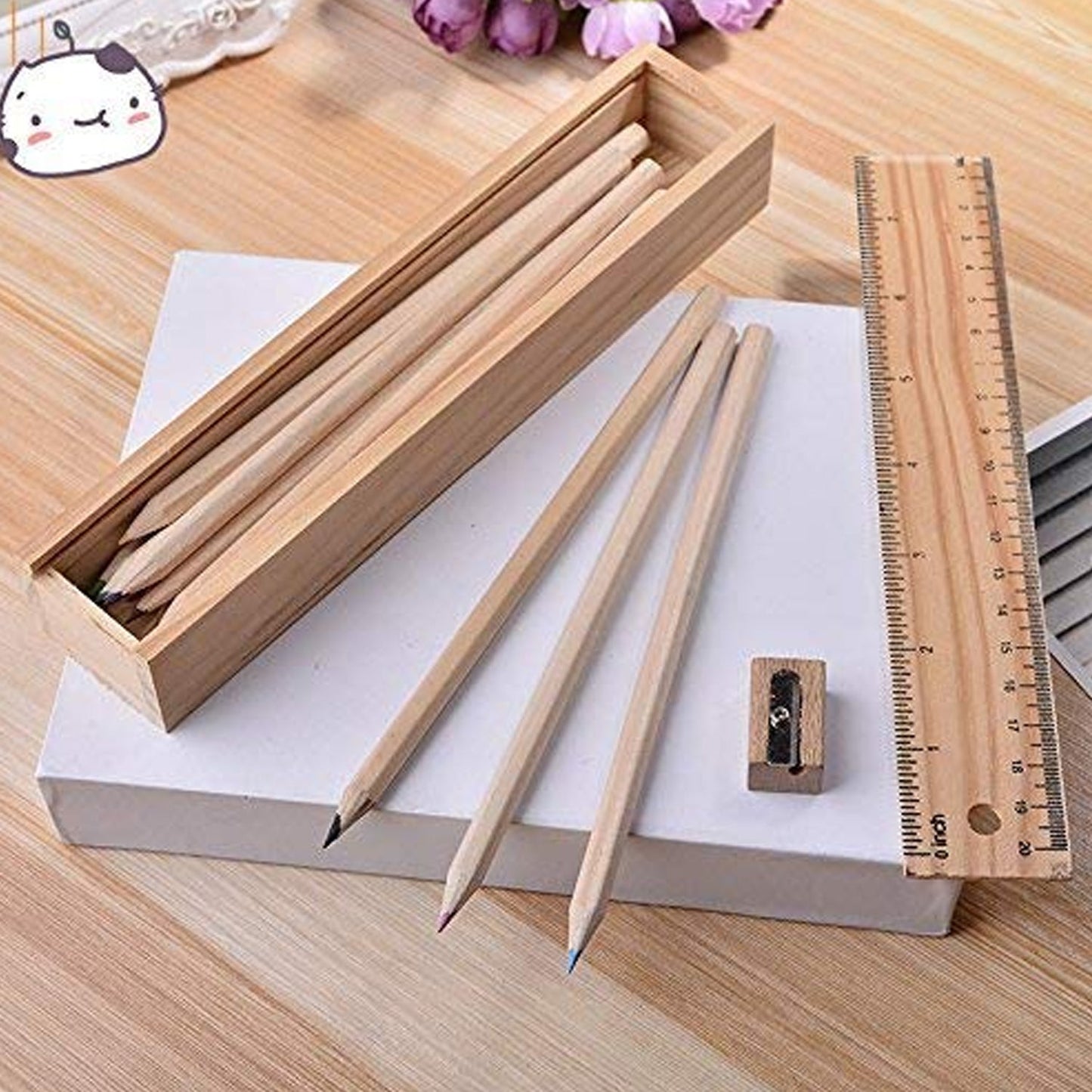 Colorful wooden pencils arranged with the sharpener and ruler on a clean background.