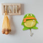Cute green frog self-adhesive wall hook with strong backing, ready for installation.