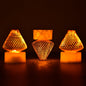 A close-up view of multiple Flameless LED Tea Light Candles glowing warmly on a dark surface.