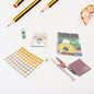 Vibrant cartoon stationery box with a notebook, pen, and eraser for school kids.