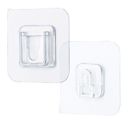 Single clear adhesive hook securely mounted on a smooth wall surface.