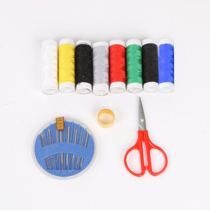 Sewing kit for home tailoring with bobbins, threads, and scissors.