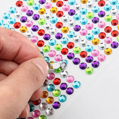 Decorative self adhesive stones arranged for a jewelry making design.