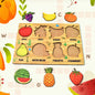 Wooden Fruit Puzzle board with colourful fruit shapes displayed on a white background.