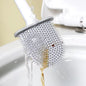 Silicone toilet brush with holder mounted on a clean bathroom wall.