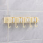 Self-adhesive broom and mop holder rack mounted on wall with utility hooks
