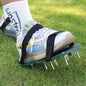 Pair of green Lawn Aerator Sandals with sharp spikes, ready for garden use.