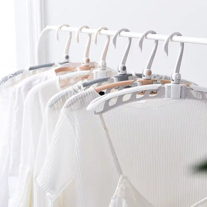 Adjustable arms of the folding clothes hanger demonstrated.
