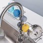 Stainless steel sink caddy organizer holding soap and sponge on kitchen sink
