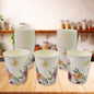 Disposable paper cups in mixed colours and designs, ready for use.