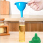 Green silicone funnel making liquid transfer easy in a modern kitchen setup.