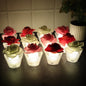 Set of Rose Shaped Flameless LED Candles glowing softly with glass holders