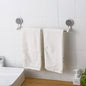 Self-adhesive towel rod mounted securely in a bathroom holding towels