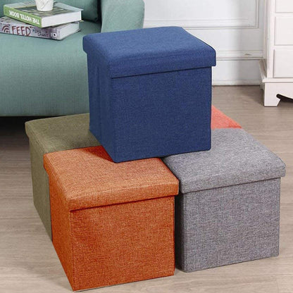 A versatile storage stool serving as a footrest next to a sofa, highlighting its multipurpose use.