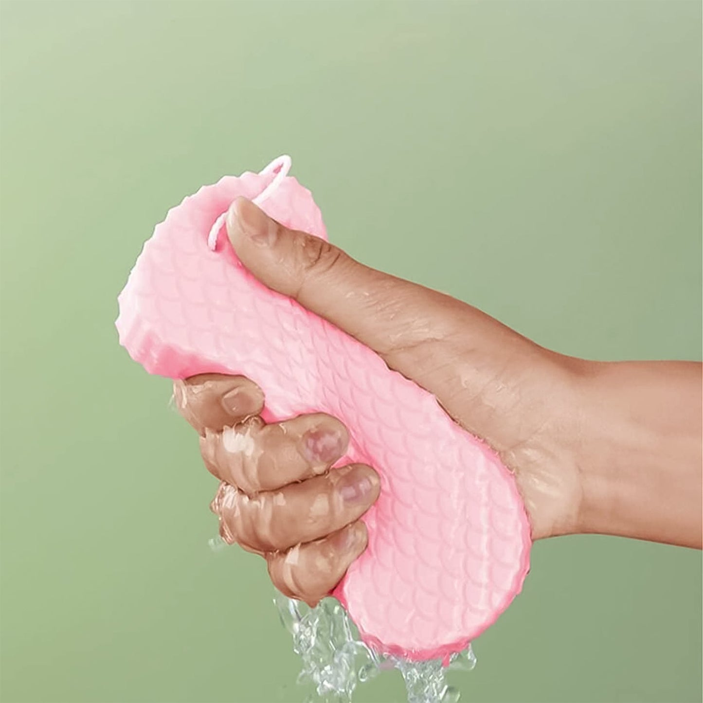 Person gently using the exfoliating sponge on their arm for smooth skin.