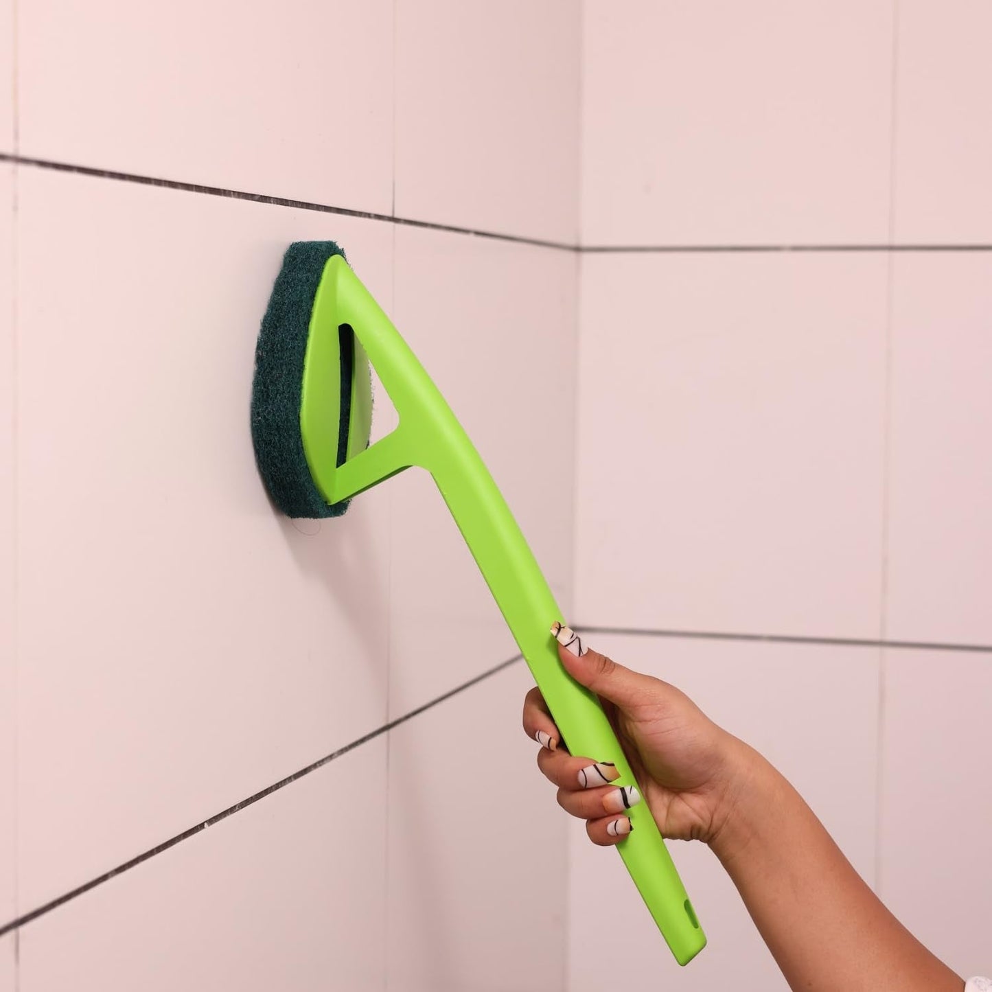 Close-up of the triangular sponge head on the long handle scrubber, ideal for corners.