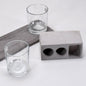 Elegant wine glass holder set with two glasses on a marble base, ideal for home decor.