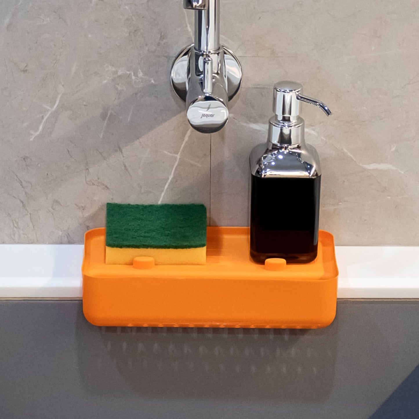 Multifunctional plastic sink drainer shelf from Garth, shown in a kitchen sink with vegetables draining.
