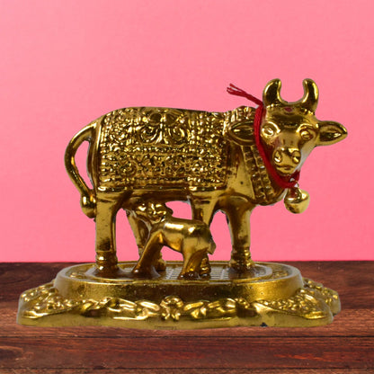 Sacred metal Kamdhenu Cow and calf idol in golden finish