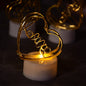 A close-up view of three glowing multicolor flameless heart candles, showcasing their realistic flickering effect.