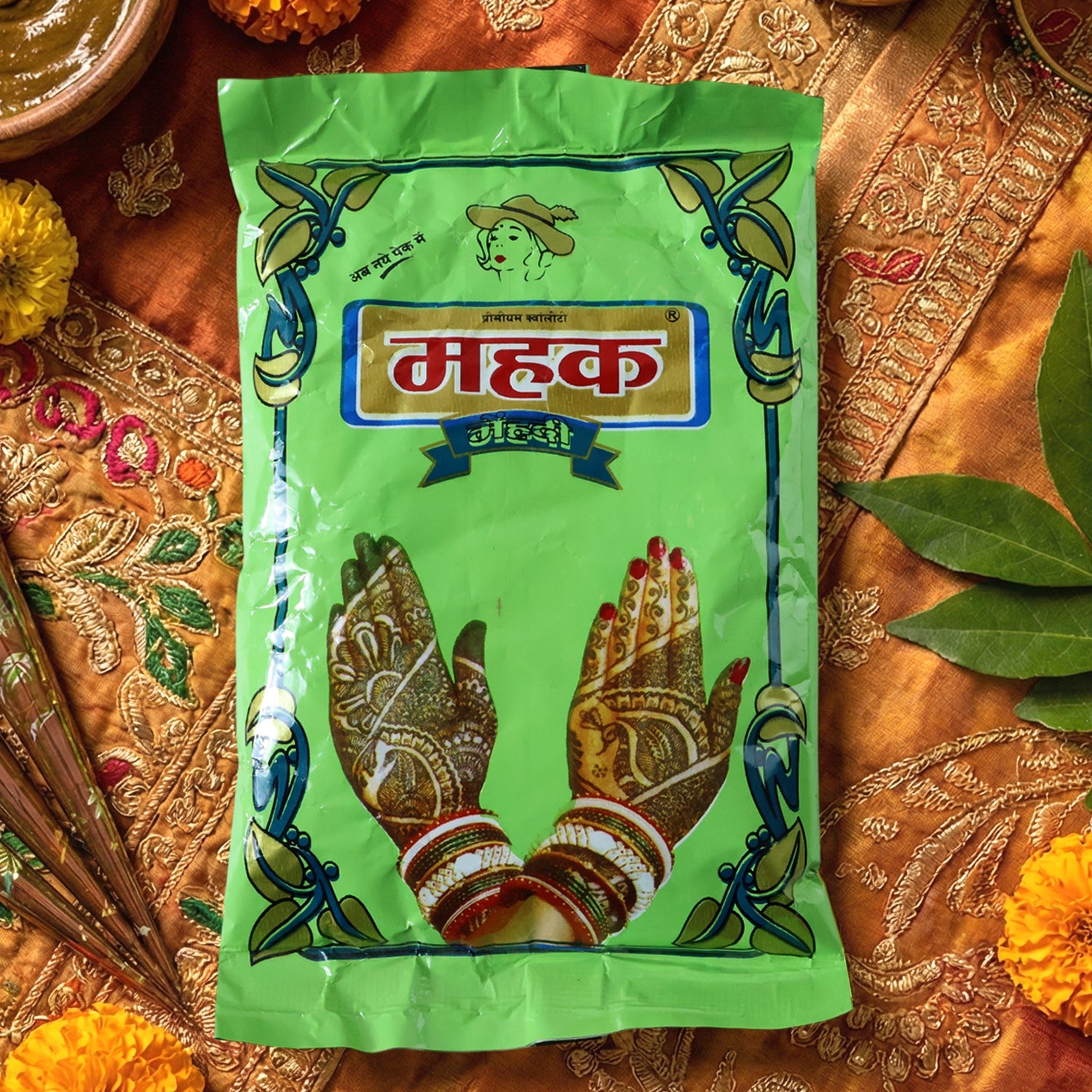 Woman applying Herbal Mehndi Powder paste to hand showcasing henna art