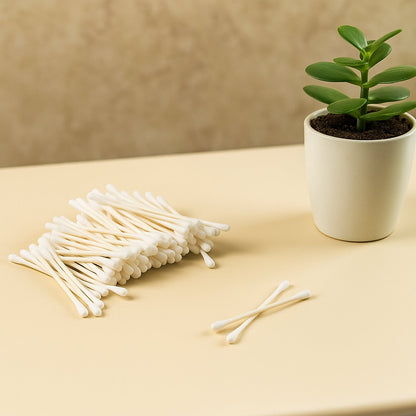 Side view of soft, tightly wound cotton tips on paper sticks.