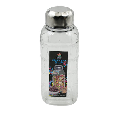 Transparent mukhwas bottle sitting on a kitchen counter with snacks