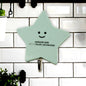 A set of strong self-adhesive hooks displayed neatly on a tiled kitchen wall, ready for use.