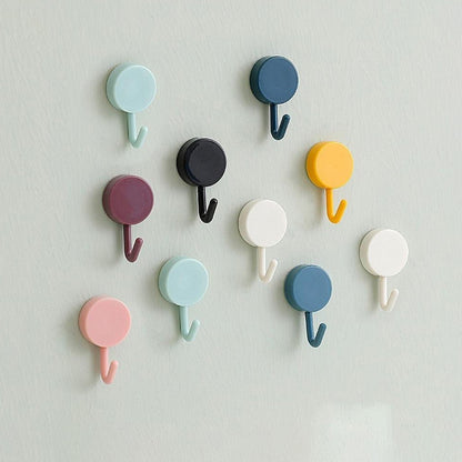 Pack of 10 transparent self-adhesive wall hooks on a white surface.