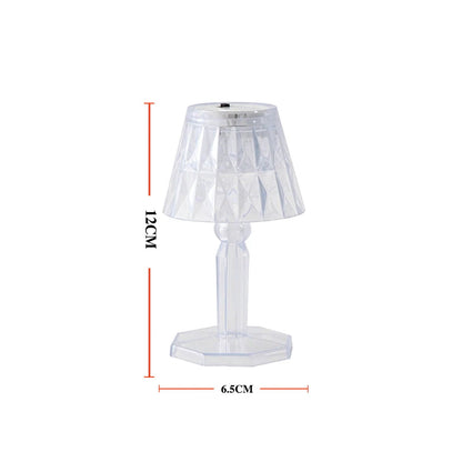 A modern mini crystal table lamp glowing softly in a contemporary interior.