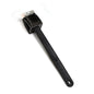 Black silicone toilet brush with its draining holder, ready for use in a modern bathroom.